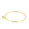 This ring features a small 2mm brilliant-cut diamond set on a slim 14K recycled gold band