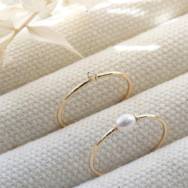 This ring features a small 2mm brilliant-cut diamond set on a slim 14K recycled gold band