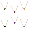A vibrant heart shaped gemstone pendant on a dainty 14-karat gold chain. 