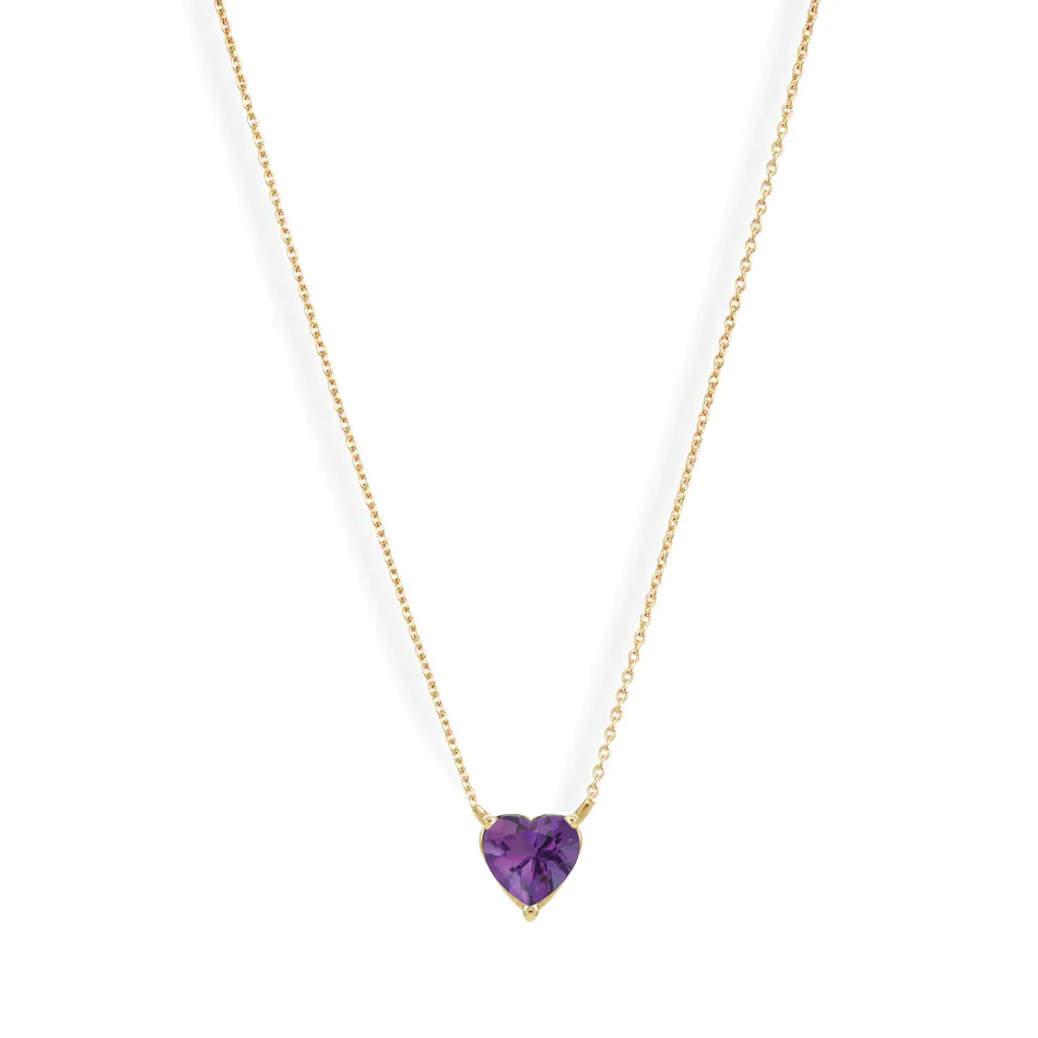 A vibrant heart shaped gemstone pendant on a dainty 14-karat gold chain. 