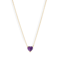 A vibrant heart shaped gemstone pendant on a dainty 14-karat gold chain. 