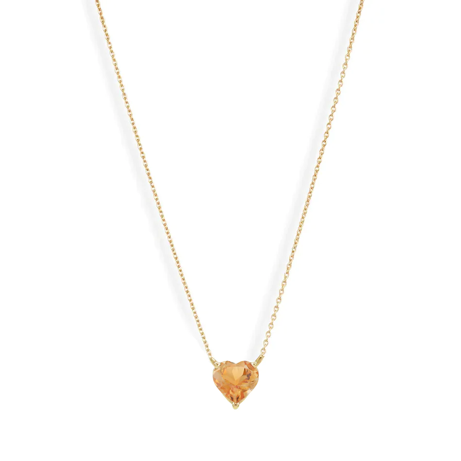 A vibrant heart shaped gemstone pendant on a dainty 14-karat gold chain. 