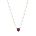 A vibrant heart shaped gemstone pendant on a dainty 14-karat gold chain. 