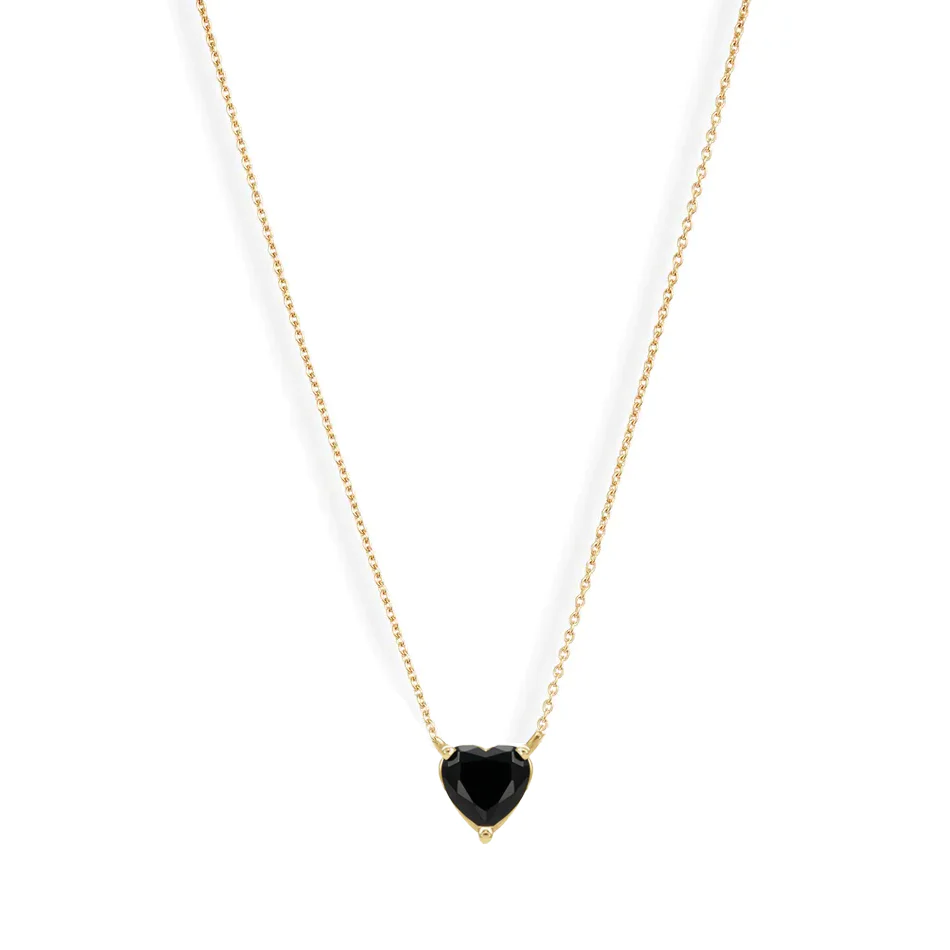 A vibrant heart shaped gemstone pendant on a dainty 14-karat gold chain. 