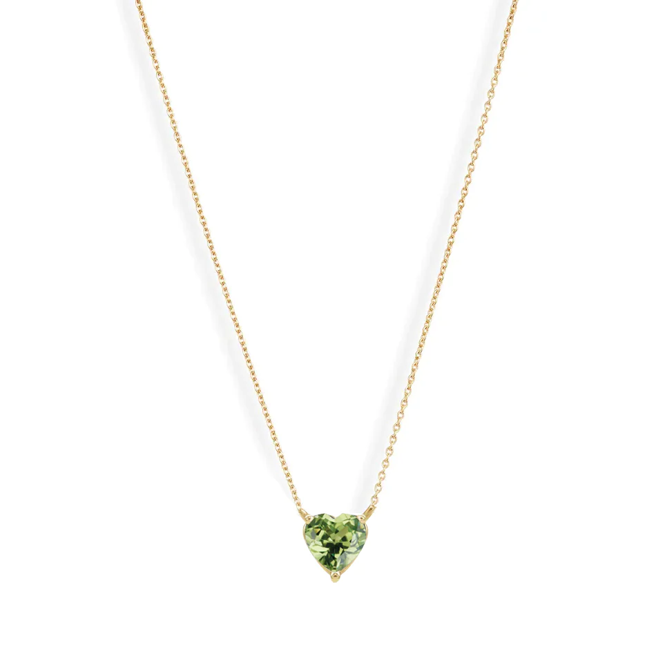 A vibrant heart shaped gemstone pendant on a dainty 14-karat gold chain. 