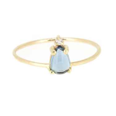 14-karat gold ring showcasing a pear-shaped swiss blue topaz with a light-catching diamond at the tip.