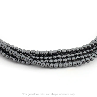 Strung 'Wrap' hematite gemstone bead necklace with attached / integrated charm clasp.
Anne Sportun tag charm, and beaded charm included.