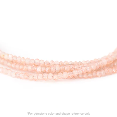 Strung 'Wrap' blush moonstone gemstone bead necklace with attached / integrated charm clasp.
Anne Sportun tag charm, and beaded charm included.