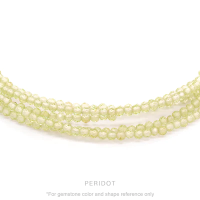 Strung 'Wrap' Peridot gemstone bead necklace with attached / integrated charm clasp.
Anne Sportun tag charm, and beaded charm included.