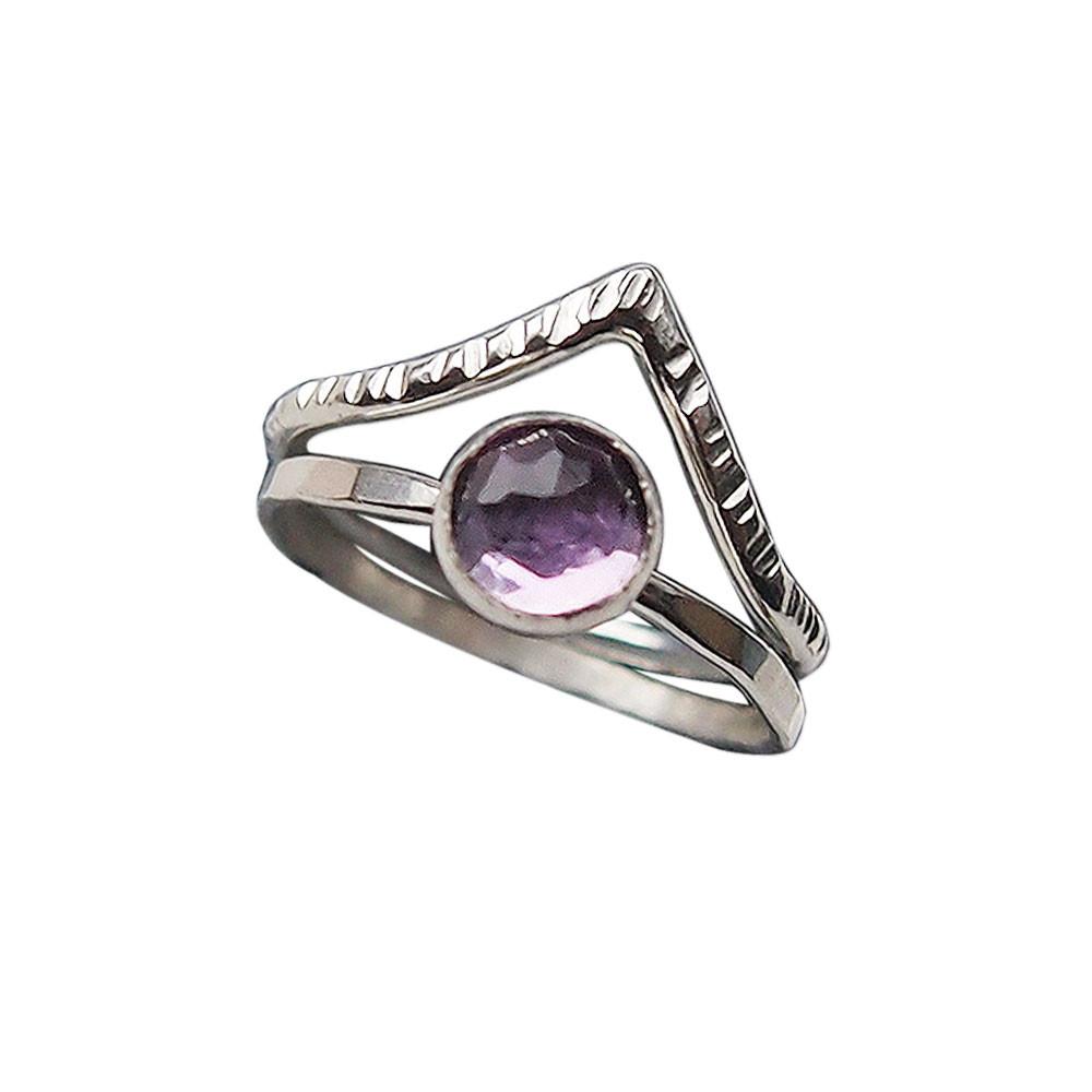 Two rings: a finely textured silver ring with a pointed chevron, and a hammered silver band set with an amethyst. 
