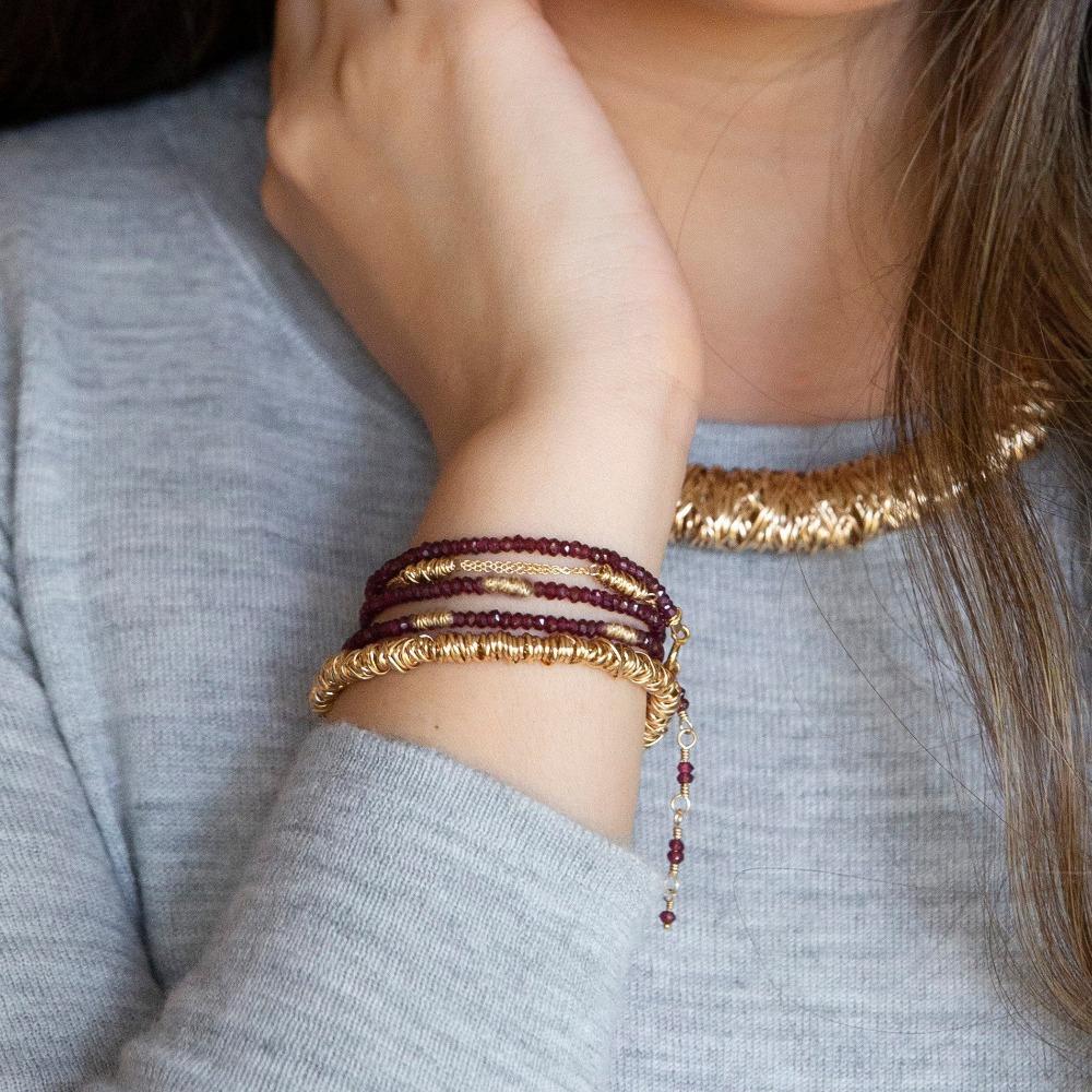 Twist Bracelet - Medium | Magpie Jewellery | Yellow Gold | On Model | Layered with Garnet Fusion Wrap Bracelet