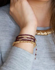 Twist Bracelet - Medium | Magpie Jewellery | Yellow Gold | On Model | Layered with Garnet Fusion Wrap Bracelet